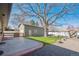 Backyard showcasing a detached garage, green lawn, and wood accents at 4625 S Huron St, Englewood, CO 80110