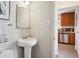 Bright bathroom featuring a pedestal sink, clean lines, and modern fixtures at 4625 S Huron St, Englewood, CO 80110