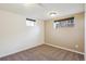 Basement bedroom featuring two windows that bring in natural light, and neutral carpet at 4625 S Huron St, Englewood, CO 80110