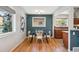 Stylish dining area with hardwood floors, a modern table, and easy access to the kitchen at 4625 S Huron St, Englewood, CO 80110