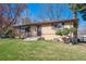 Well-maintained single-story home with brick accents, landscaped yard, and inviting entrance at 4625 S Huron St, Englewood, CO 80110