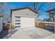 Detached garage featuring a modern door with windows, accessible via a concrete driveway at 4625 S Huron St, Englewood, CO 80110