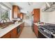 Galley kitchen with stainless appliances, wood cabinets and stone countertops at 4625 S Huron St, Englewood, CO 80110