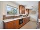 Bright kitchen featuring ample wood cabinetry and a sunlit window at 4625 S Huron St, Englewood, CO 80110