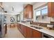 Open kitchen with stainless steel appliances, wood cabinets and eating area at 4625 S Huron St, Englewood, CO 80110