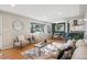 Bright living room with hardwood floors, stylish furniture, and an open layout connecting to the dining area and kitchen at 4625 S Huron St, Englewood, CO 80110