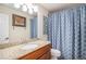 Bathroom featuring granite counters, a mirror, and a shower with a blue patterned shower curtain at 16522 Bluebonnet Dr, Parker, CO 80134