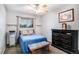 Inviting bedroom with a ceiling fan, a window, and a dresser at 16522 Bluebonnet Dr, Parker, CO 80134