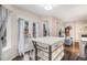 Bright breakfast nook with white island seating, and adjacent to the living room area at 16522 Bluebonnet Dr, Parker, CO 80134