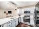 Bright kitchen featuring white cabinets, stainless appliances, and elegant chandelier at 16522 Bluebonnet Dr, Parker, CO 80134