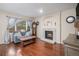 Inviting living room with hardwood floors, fireplace and a large window offering natural light at 16522 Bluebonnet Dr, Parker, CO 80134