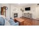 Cozy living room featuring a fireplace, hardwood floors, and stylish furnishings at 16522 Bluebonnet Dr, Parker, CO 80134