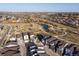 Aerial view of the neighborhood and park with pond, walking trails, and playground at 12242 W 56Th Pl, Arvada, CO 80002