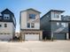 New construction, two-story home with two-car garage and contemporary design under a clear sky at 12242 W 56Th Pl, Arvada, CO 80002