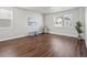 Bright flex room with wood floors, a large window, and small bar table with stools at 12242 W 56Th Pl, Arvada, CO 80002