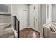 Entryway with hardwood floors, staircase, and a well-lit front door, showcasing modern design at 12242 W 56Th Pl, Arvada, CO 80002