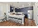 Stylish kitchen with navy blue cabinets, stainless steel appliances, and a spacious center island at 12242 W 56Th Pl, Arvada, CO 80002