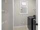 Functional laundry room featuring black washer and dryer, white wire shelving, and natural light at 12242 W 56Th Pl, Arvada, CO 80002