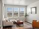 Cozy living room with natural light, modern furniture, and views of the outdoors at 12242 W 56Th Pl, Arvada, CO 80002