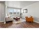 Cozy living room with ample natural light, comfortable seating, and hardwood flooring at 12242 W 56Th Pl, Arvada, CO 80002
