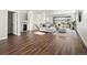 Open-concept living room with hardwood flooring, comfy seating, and convenient wet bar at 12242 W 56Th Pl, Arvada, CO 80002