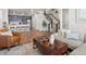 Open concept living space with hardwood floors, a modern staircase, and stylish furnishings at 12242 W 56Th Pl, Arvada, CO 80002
