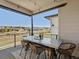 Inviting covered patio featuring a large table, wicker chairs, and scenic neighborhood views at 12242 W 56Th Pl, Arvada, CO 80002