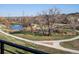 Scenic view of a pond with walking trails and lush greenery from the balcony at 12242 W 56Th Pl, Arvada, CO 80002