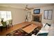 Bright living room with a stone fireplace, wooden floors, and a ceiling fan at 7369 S Gore Range Rd # 103, Littleton, CO 80127