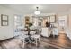 Bright dining room leading into a fully-equipped kitchen and featuring hardwood floors at 7957 Elm St, Louviers, CO 80131