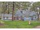 Exterior view of the blue home showcasing its well-manicured lawn and complementary detached structure at 7957 Elm St, Louviers, CO 80131