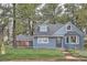 Charming blue two-story home with a well-maintained front yard and mature trees at 7957 Elm St, Louviers, CO 80131