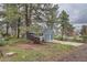 View of the exterior of the property, showcasing the home and wooded yard at 7957 Elm St, Louviers, CO 80131