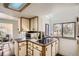 Bright kitchen with a cooktop and window above for lots of natural light at 7957 Elm St, Louviers, CO 80131