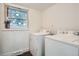 Laundry room featuring a washer and dryer, as well as a window for natural light at 7957 Elm St, Louviers, CO 80131