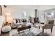 Cozy living room featuring a wood-burning stove, comfortable seating, and natural light at 7957 Elm St, Louviers, CO 80131