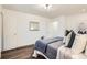 Bright main bedroom with hardwood floors, white trim, and a walk-in closet at 7957 Elm St, Louviers, CO 80131