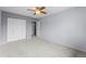 Bedroom featuring new carpet, fan, and large closet at 2285 Coronado Pkwy # D, Denver, CO 80229