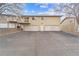 Two-story home with multiple garage doors and gray asphalt under partly cloudy sky at 2285 Coronado Pkwy # D, Denver, CO 80229