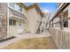 A charming tan two-story home boasts a stone accent wall and a well-maintained front yard with mature trees at 2285 Coronado Pkwy # D, Denver, CO 80229