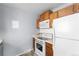 Cozy kitchen with white appliances and warm wood cabinets at 2285 Coronado Pkwy # D, Denver, CO 80229