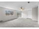 Open-concept living room with ceiling fan, carpet, and sliding door at 2285 Coronado Pkwy # D, Denver, CO 80229
