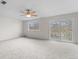 Spacious living room with slider to balcony, ceiling fan, and light gray carpet at 2285 Coronado Pkwy # D, Denver, CO 80229