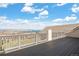 Large balcony with stunning view of lake and mountains beyond the railing at 7615 Lemon Gulch Way, Castle Rock, CO 80108