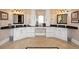 Spacious bathroom vanity with dual sinks, granite countertop, ample storage, and decorative lighting at 7615 Lemon Gulch Way, Castle Rock, CO 80108
