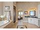Luxury bathroom with a soaking tub, tiled floors, a walk-in shower, and views into the main bedroom at 7615 Lemon Gulch Way, Castle Rock, CO 80108
