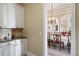 Butler pantry with custom cabinets and arched doorway to the formal dining room at 7615 Lemon Gulch Way, Castle Rock, CO 80108