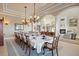 Formal dining room featuring a large table, chandelier, and elegant decor throughout at 7615 Lemon Gulch Way, Castle Rock, CO 80108