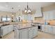 Spacious kitchen with a center island, modern appliances, and custom cabinetry at 7615 Lemon Gulch Way, Castle Rock, CO 80108