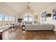 Spacious living room with fireplace, large windows, hardwood floors, and vaulted ceilings at 7615 Lemon Gulch Way, Castle Rock, CO 80108